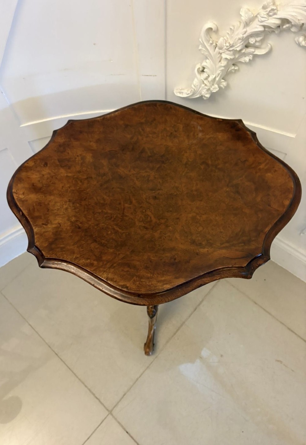 An antique Victorian burr walnut side table featuring a shaped scalloped top, a spiral carved pedestal column, and three carved cabriole legs. View IX