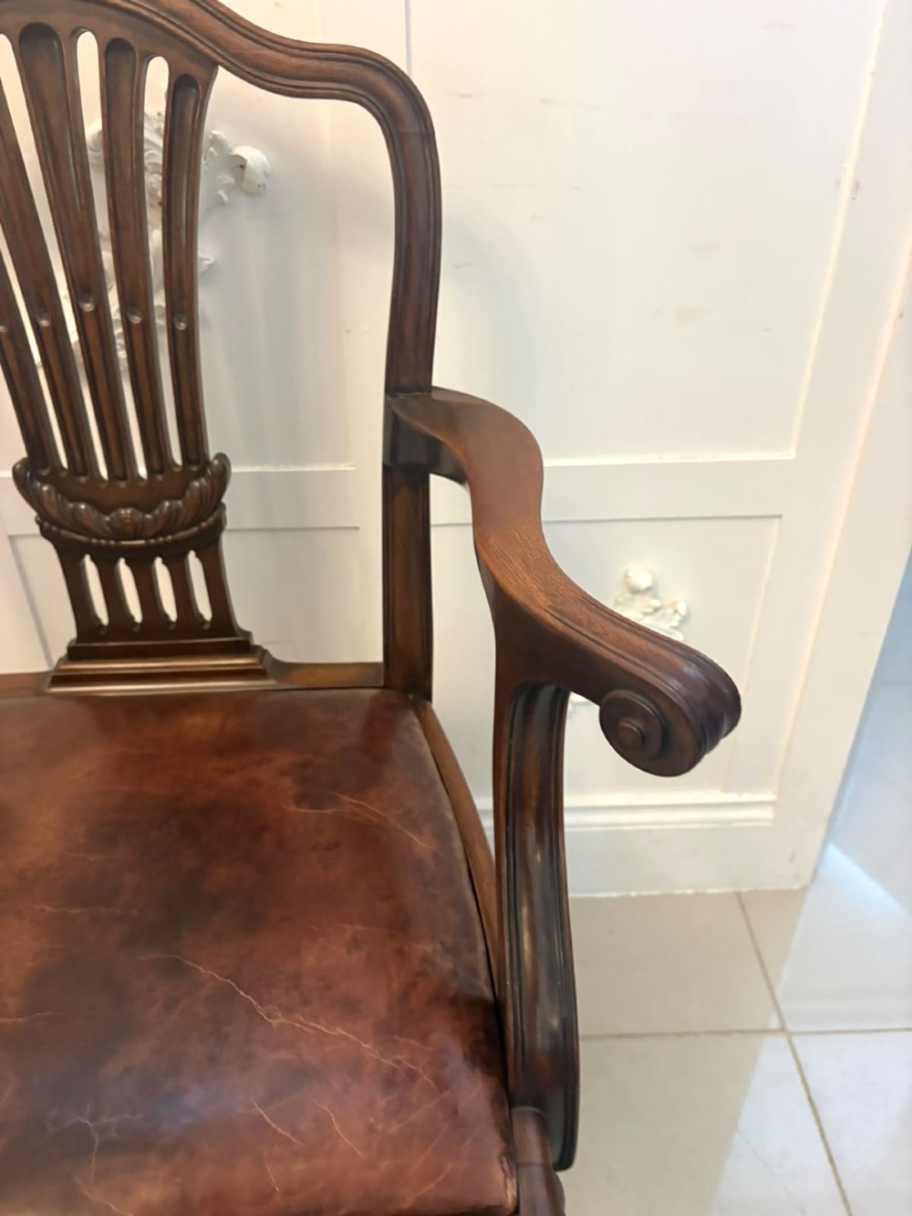 A set of eight Victorian mahogany Hepplewhite style dining chairs with carved shield backs and tan leather seats. View VIII