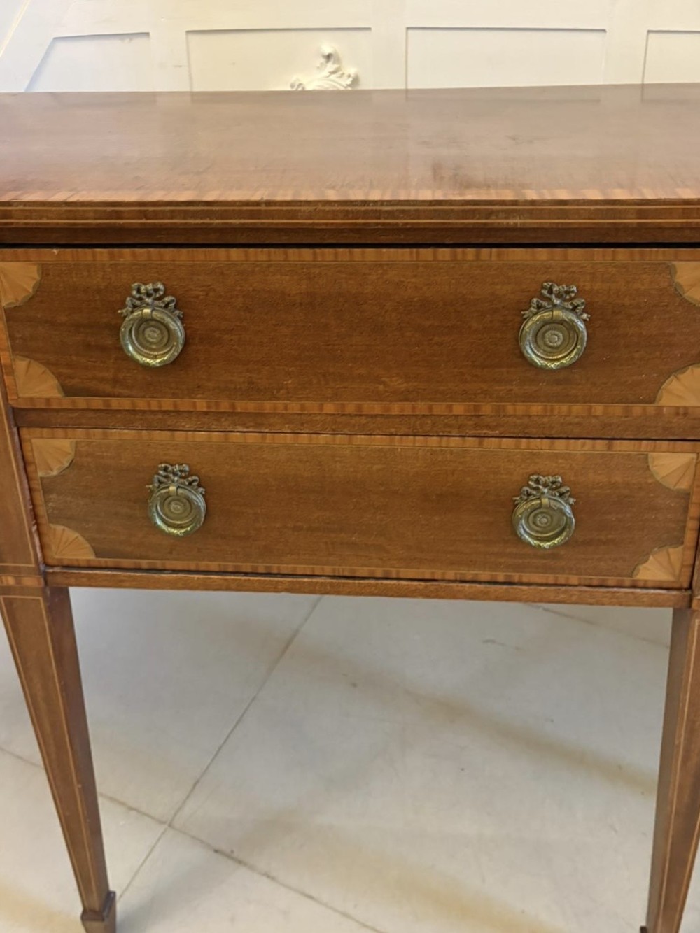 An Edwardian mahogany sideboard featuring satinwood crossbanded inlay, central drawers, flanking curved cupboards, brass ring handles, and square tapered legs. View IV