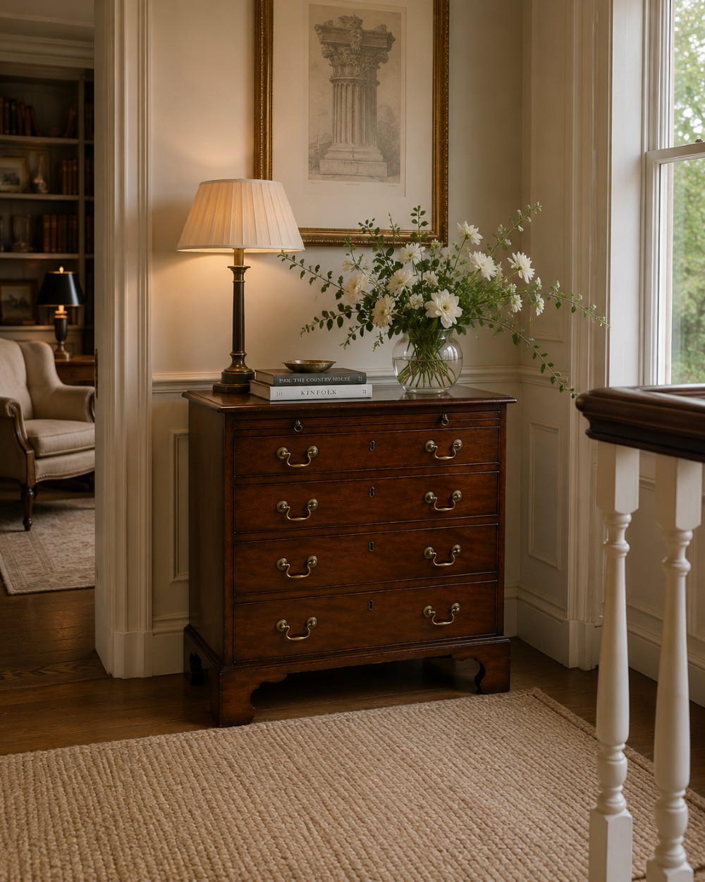 A small Georgian mahogany chest of drawers featuring four graduated drawers with brass swan-neck handles, a pull-out brushing slide, and bracket feet. View II