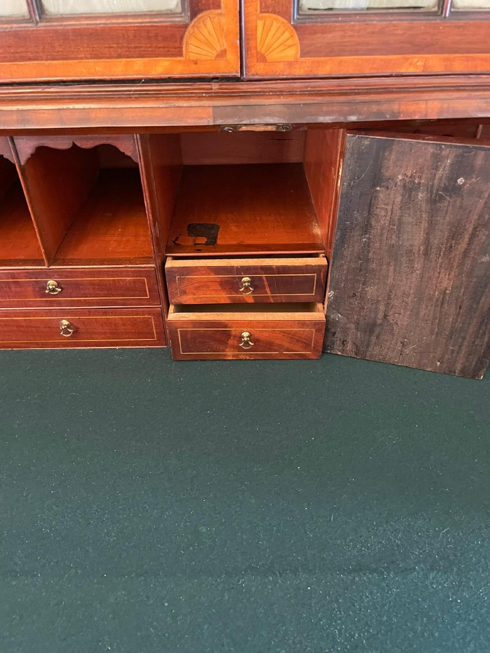 An 18th-century George III mahogany bureau bookcase featuring an upper astragal glazed cabinet above a slanted writing desk with four inlaid drawers and brass handles. View II