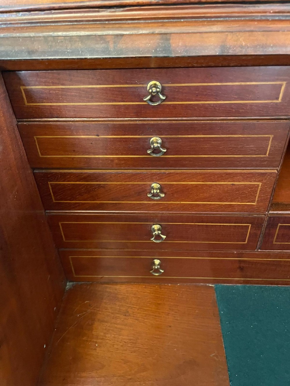 An 18th-century George III mahogany bureau bookcase featuring an upper astragal glazed cabinet above a slanted writing desk with four inlaid drawers and brass handles. View III