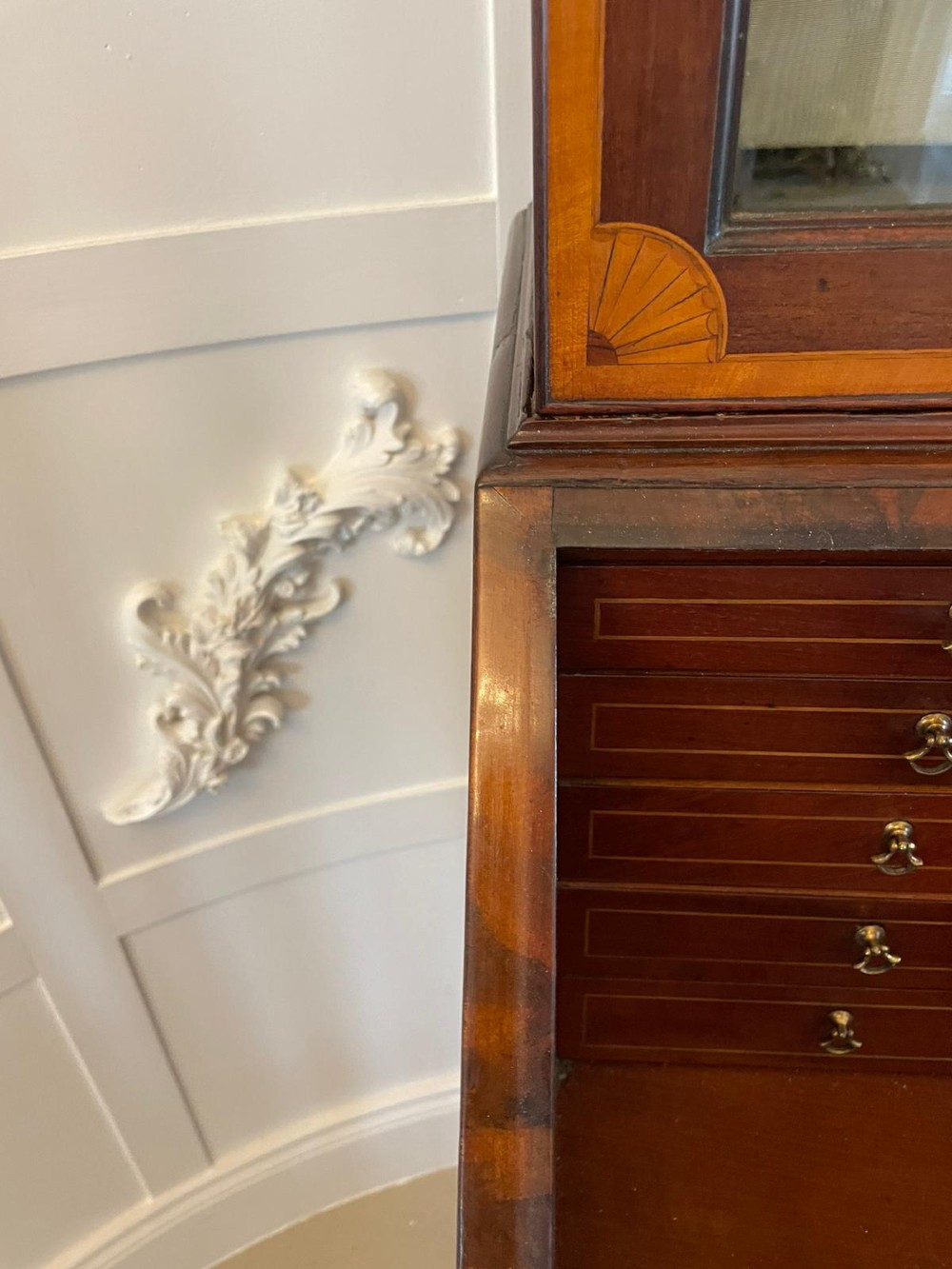 An 18th-century George III mahogany bureau bookcase featuring an upper astragal glazed cabinet above a slanted writing desk with four inlaid drawers and brass handles. View VI