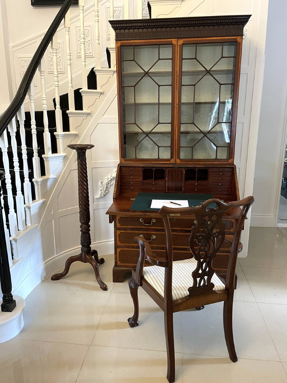 An 18th-century George III mahogany bureau bookcase featuring an upper astragal glazed cabinet above a slanted writing desk with four inlaid drawers and brass handles. View IX