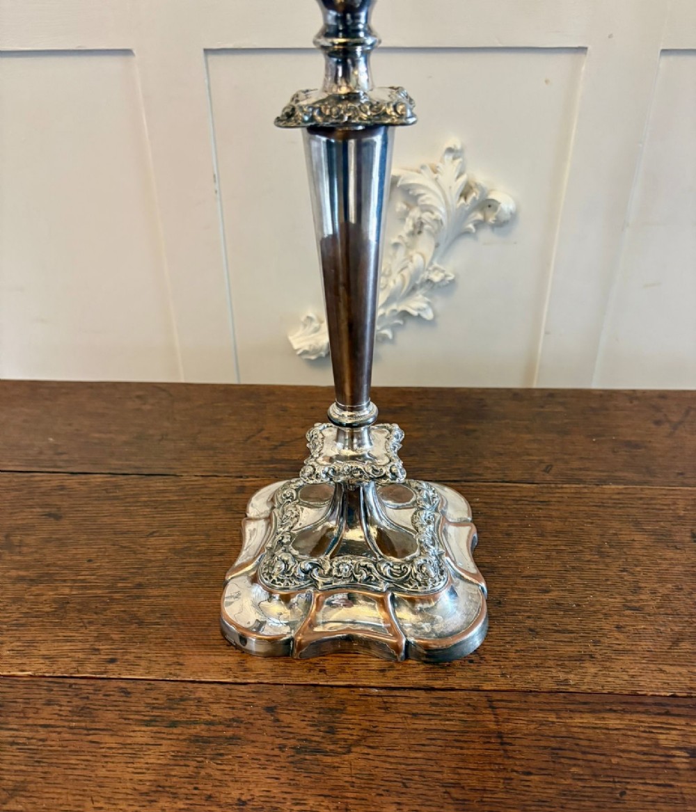 A Victorian silver-plated five-branch candelabra featuring scroll arms, ornate foliate moulding, and a shaped pedestal base. View V