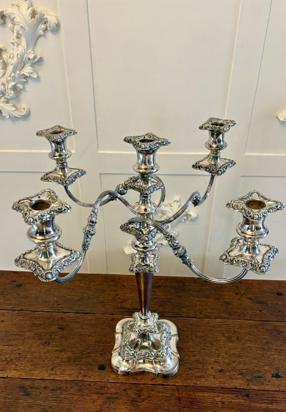 A Victorian silver-plated five-branch candelabra featuring scroll arms, ornate foliate moulding, and a shaped pedestal base. View X