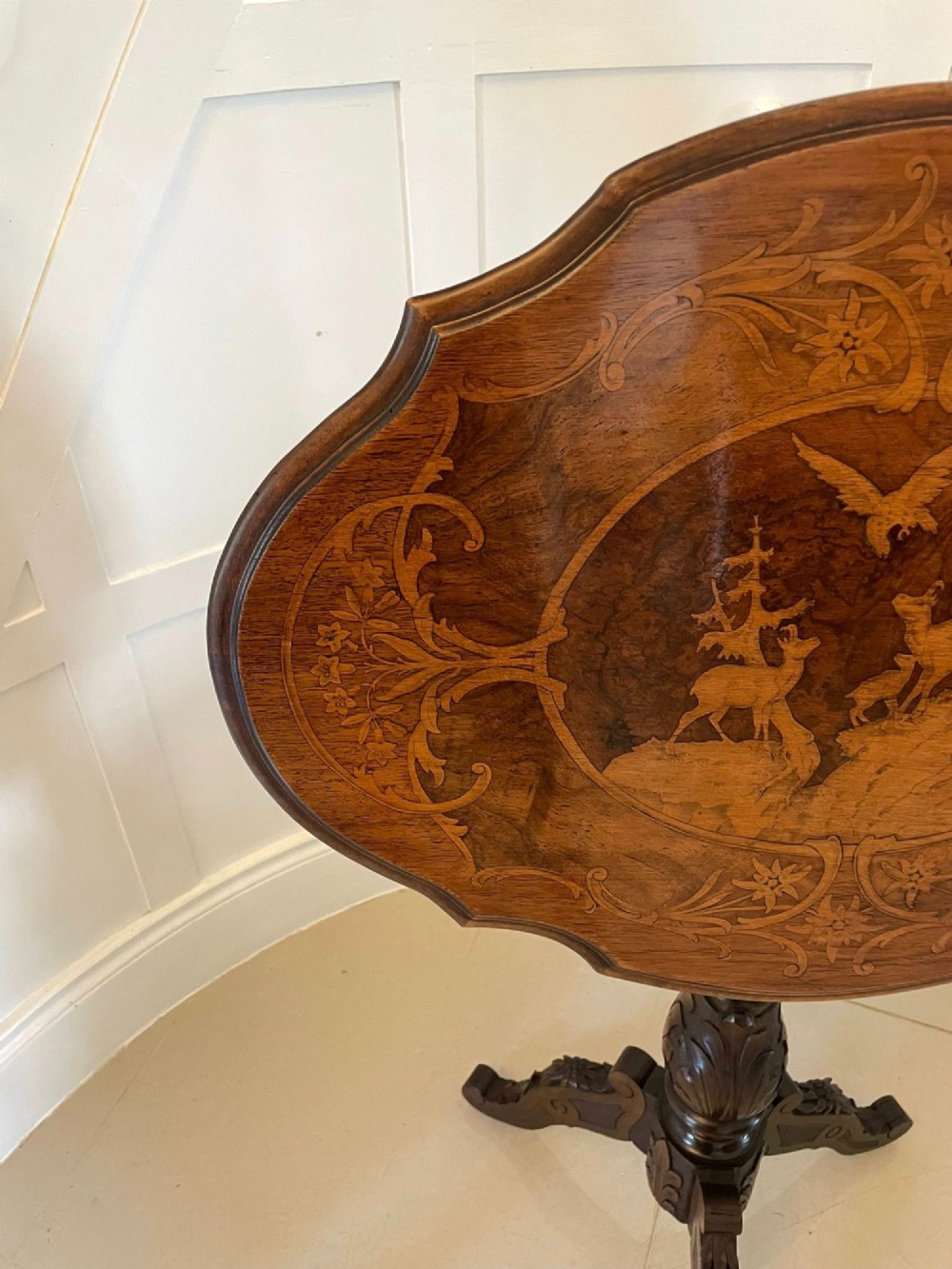 An antique walnut tilt-top side table featuring an oval top with elaborate marquetry depicting alpine wildlife and a carved tripod pedestal base. View XIV
