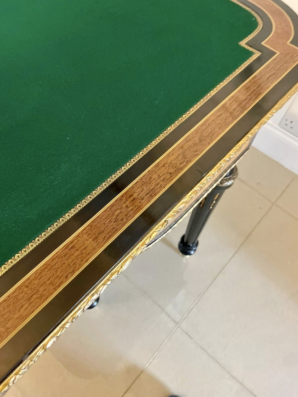 An antique French ebonised and walnut marquetry fold-over card table with gilt bronze mounts and fluted legs. View III