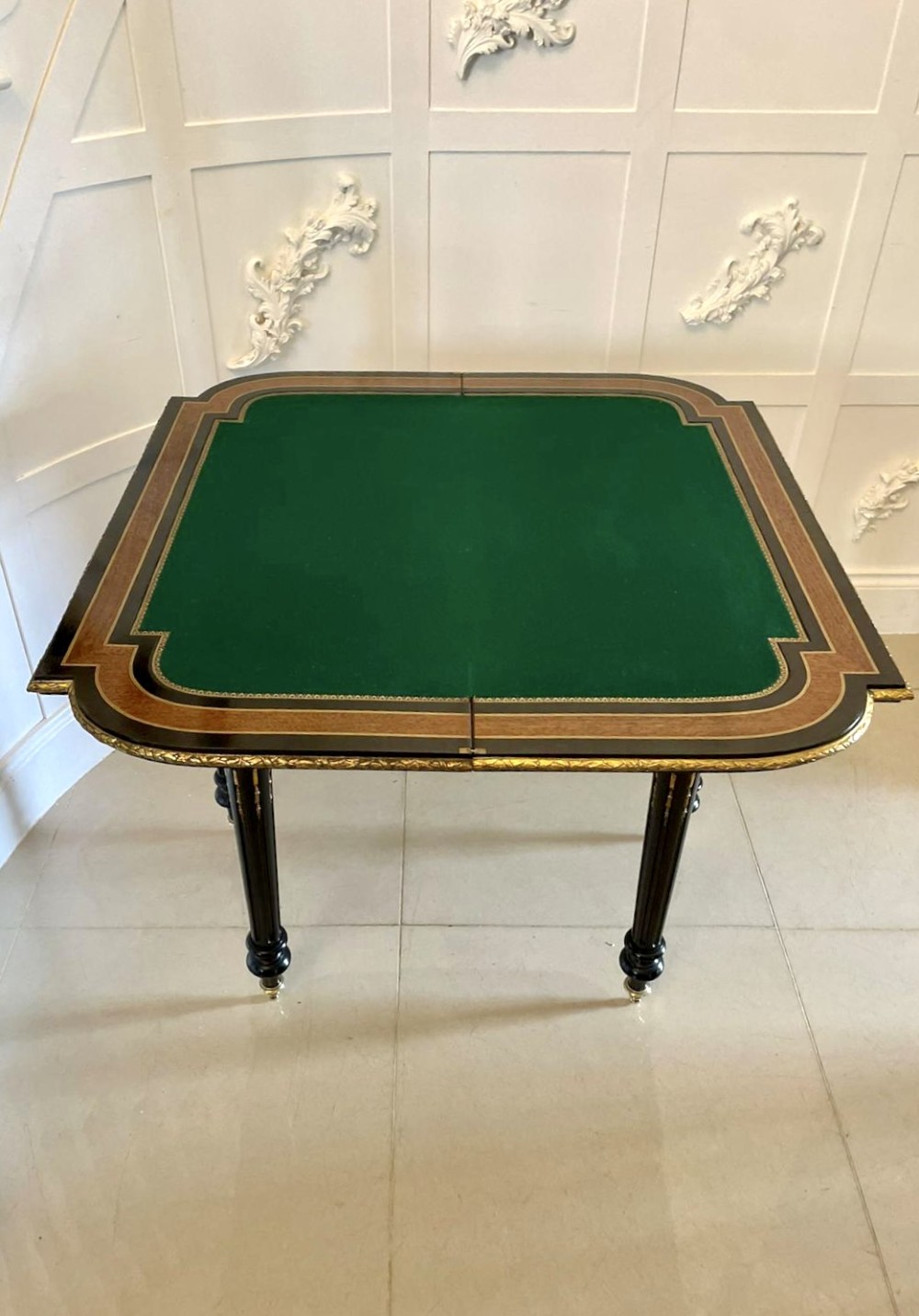 An antique French ebonised and walnut marquetry fold-over card table with gilt bronze mounts and fluted legs. View IV