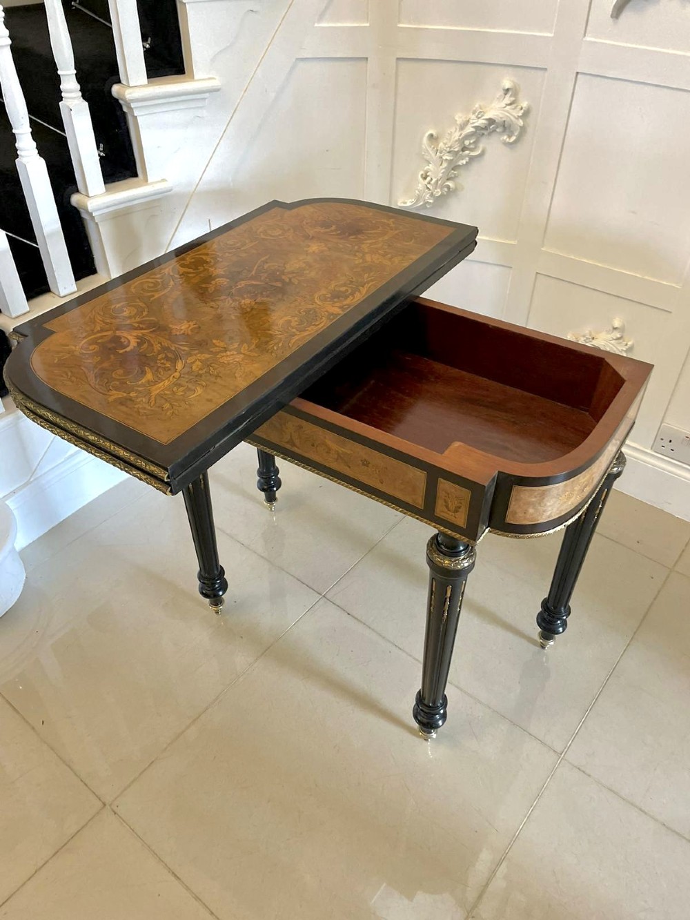 An antique French ebonised and walnut marquetry fold-over card table with gilt bronze mounts and fluted legs. View V