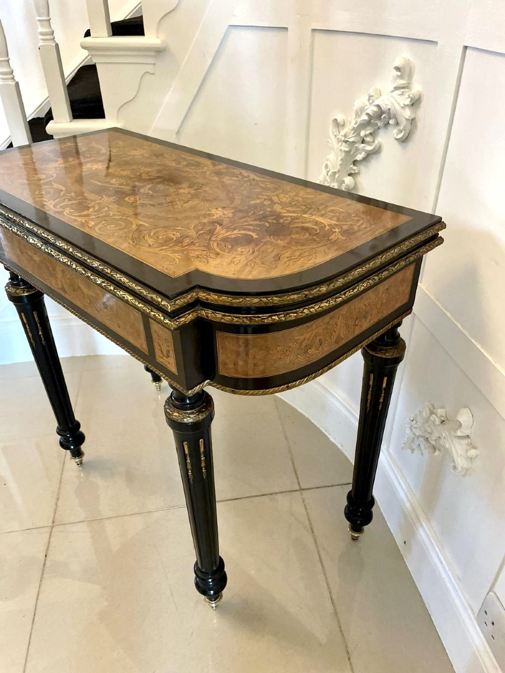An antique French ebonised and walnut marquetry fold-over card table with gilt bronze mounts and fluted legs. View XI