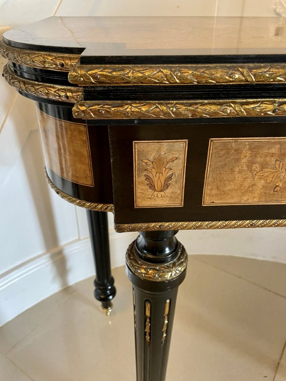 An antique French ebonised and walnut marquetry fold-over card table with gilt bronze mounts and fluted legs. View XIII