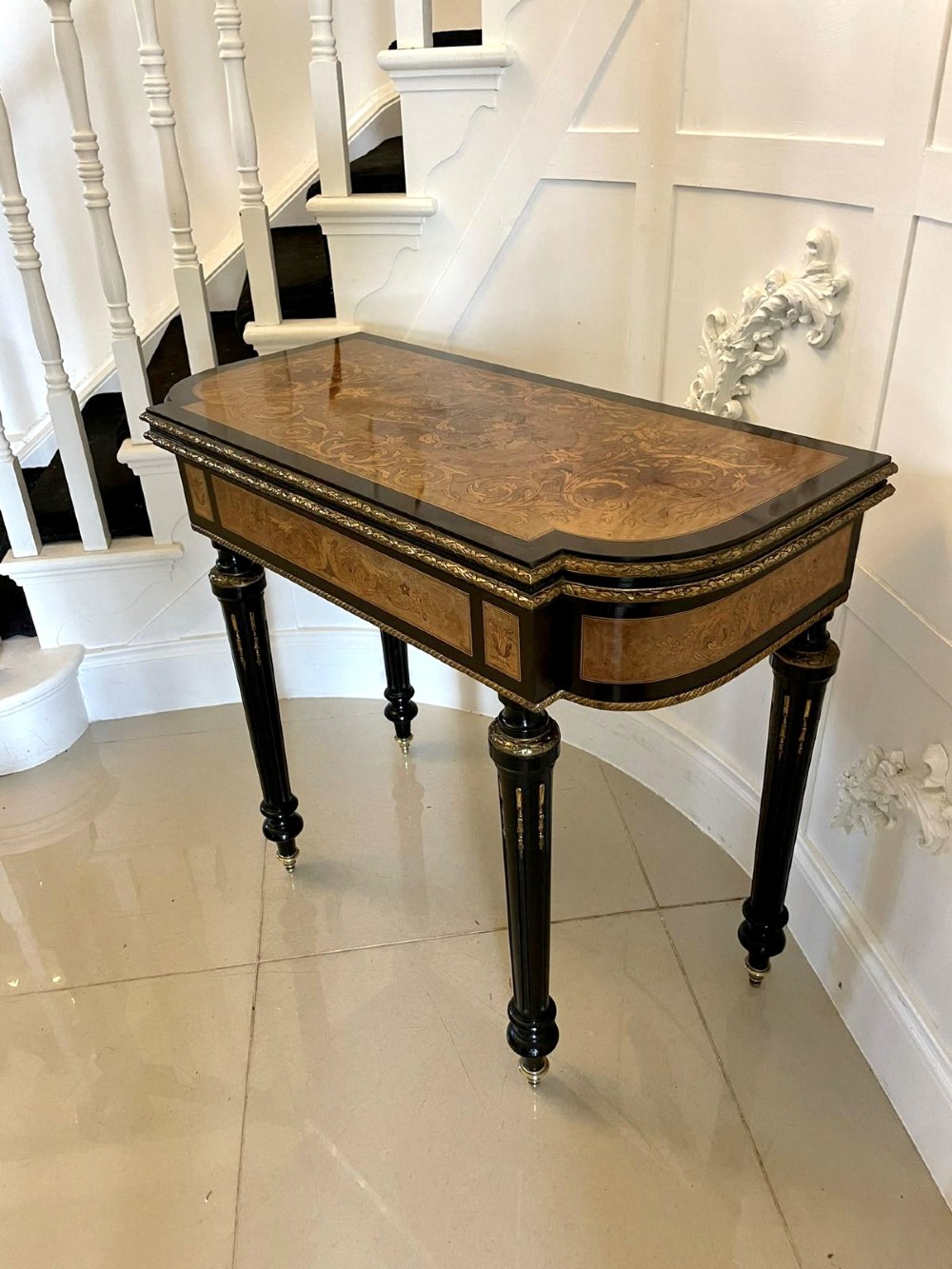 An antique French ebonised and walnut marquetry fold-over card table with gilt bronze mounts and fluted legs. View XIV