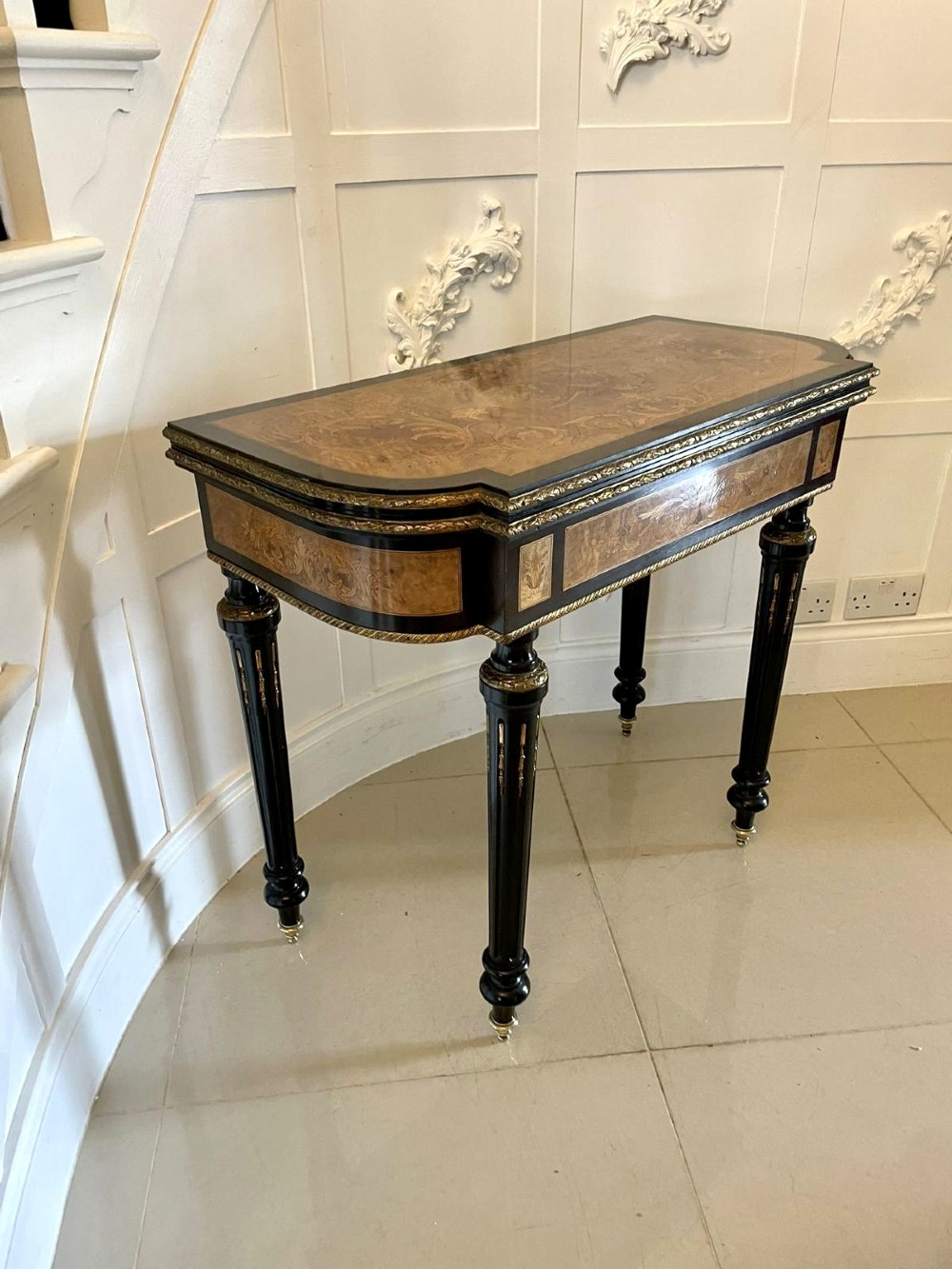 An antique French ebonised and walnut marquetry fold-over card table with gilt bronze mounts and fluted legs. View XV