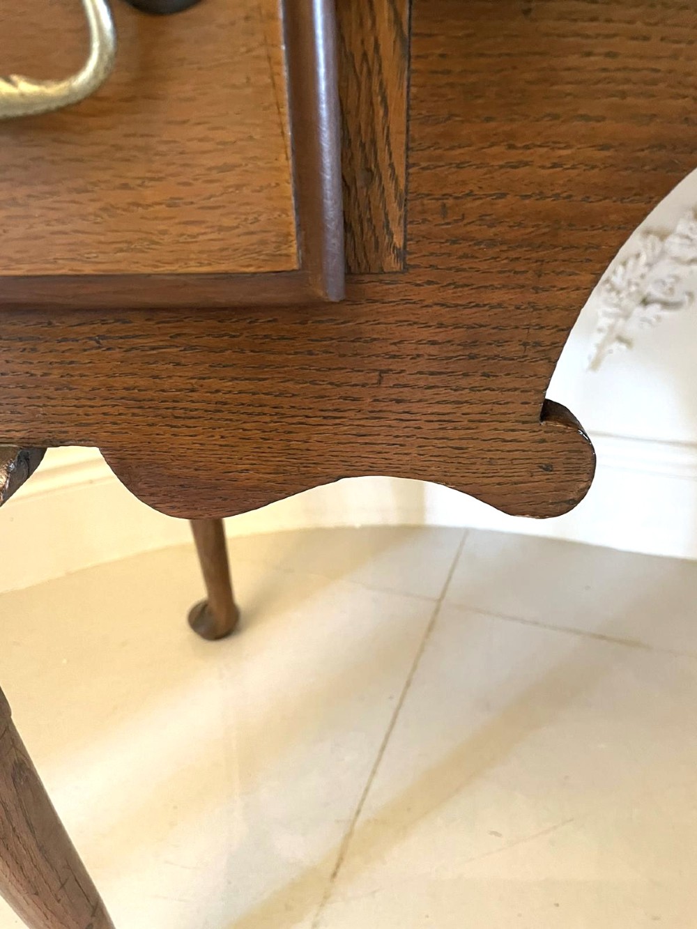 An 18th-century George III oak lowboy featuring three drawers with brass swan-neck handles, a shaped apron, and cabriole legs ending in pad feet. View IV