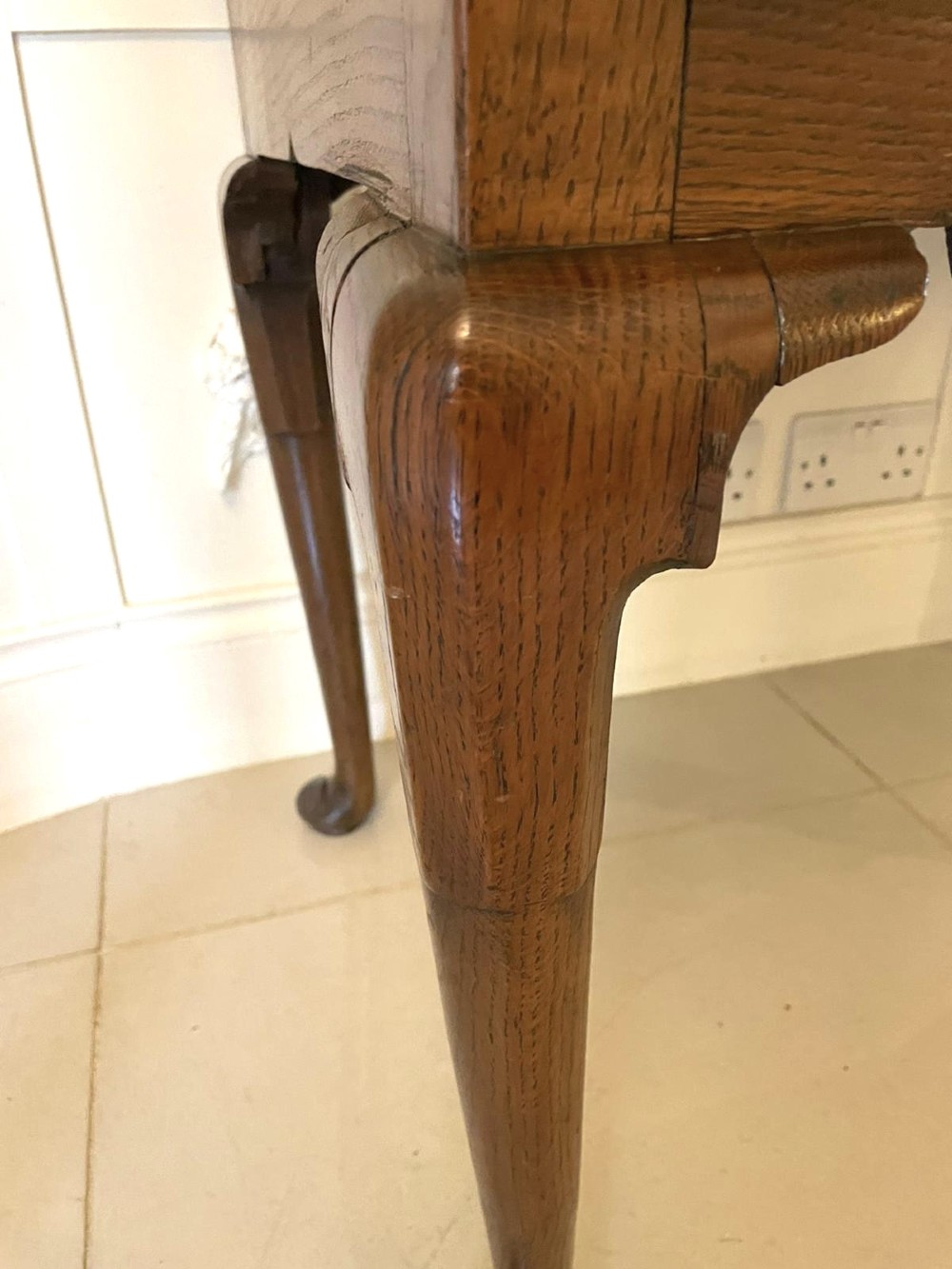 An 18th-century George III oak lowboy featuring three drawers with brass swan-neck handles, a shaped apron, and cabriole legs ending in pad feet. View VII