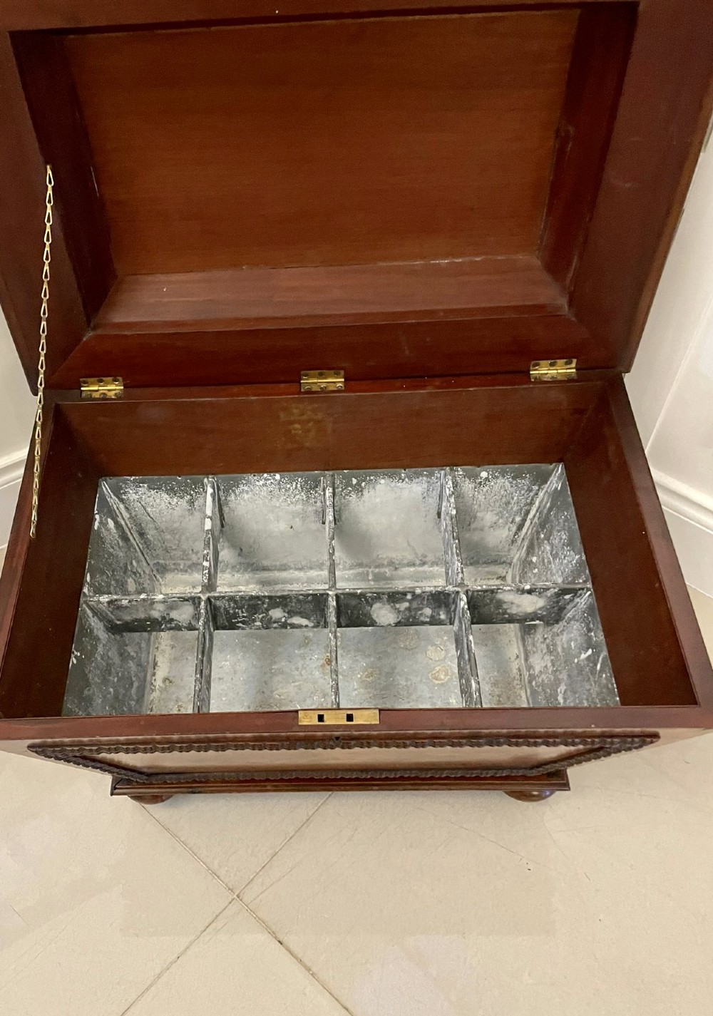 A William IV sarcophagus-shaped mahogany wine cooler featuring carved egg-and-dart moulding and a stepped lid set on short legs with castors. View III