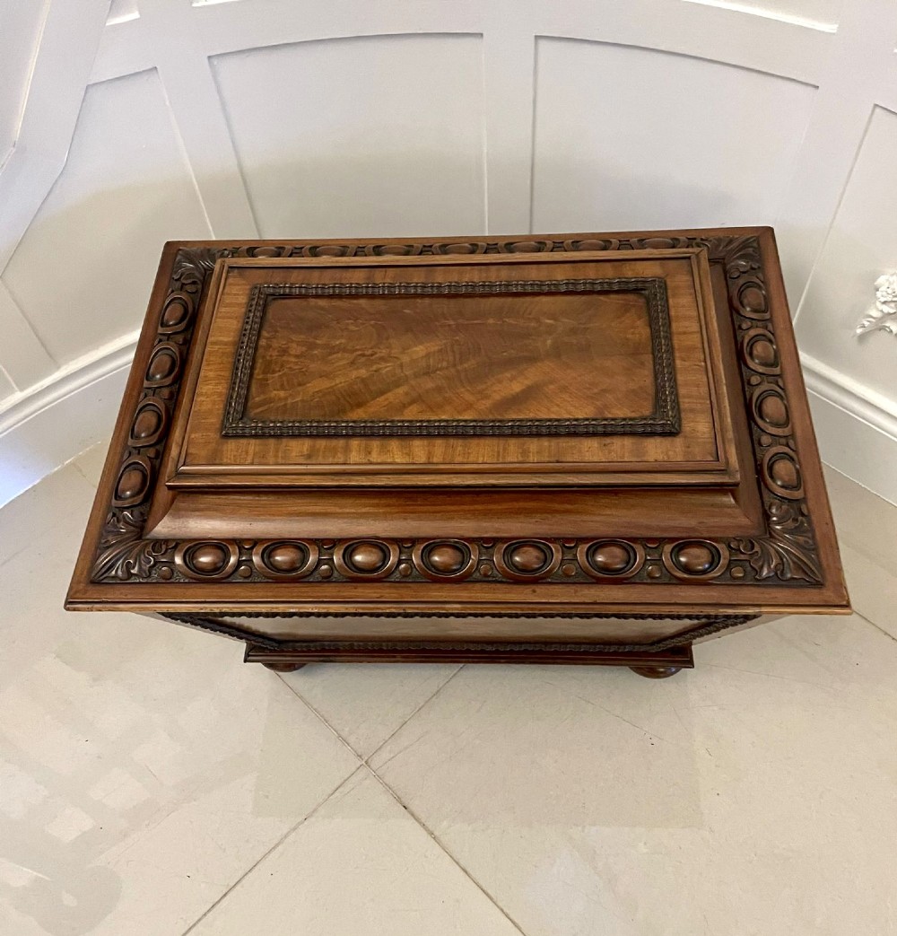 A William IV sarcophagus-shaped mahogany wine cooler featuring carved egg-and-dart moulding and a stepped lid set on short legs with castors. View VIII