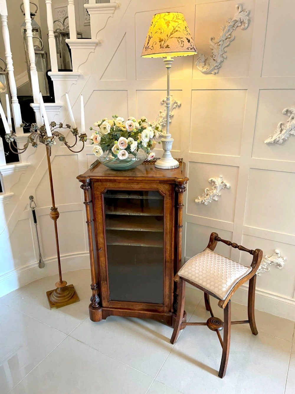 An antique Victorian wooden music chair featuring curved side supports, a turned back rail, splayed legs connected by a central stretcher, and a cream geometric upholstered seat. View VIII