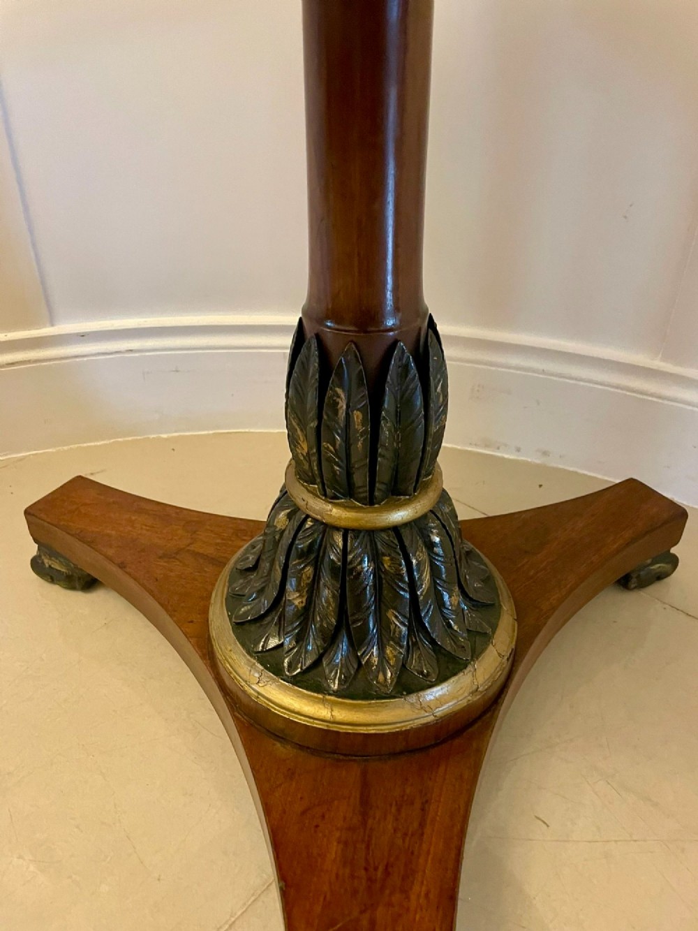 A circular Victorian centre table featuring a geometric specimen marble inlaid top resting on a dark carved mahogany pedestal with a triform base. View III