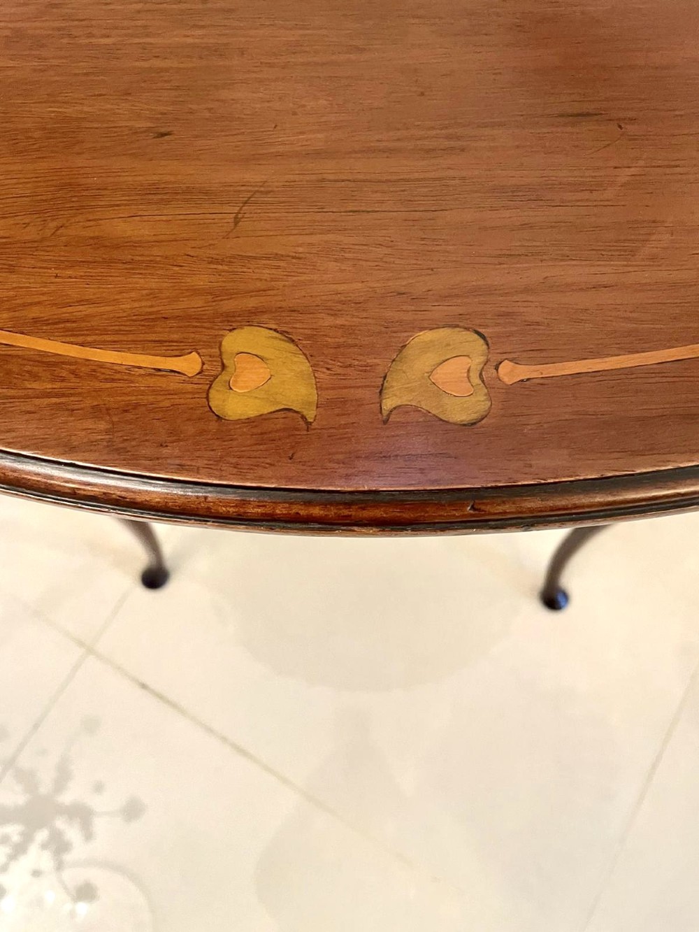An oval mahogany lamp table featuring Art Nouveau central marquetry inlay, slender curved legs, and a lower oval shelf. View III