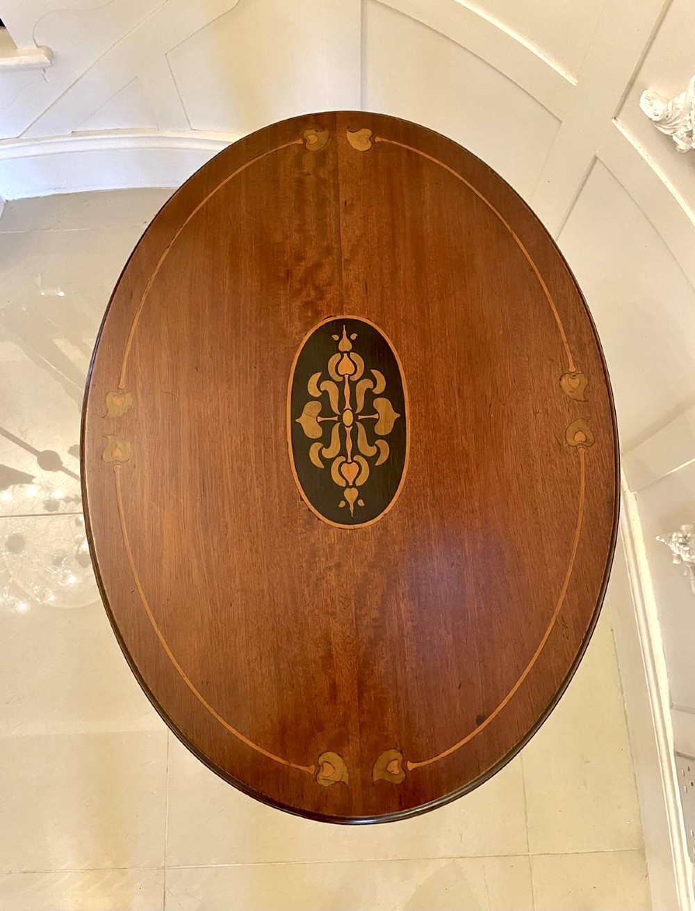 An oval mahogany lamp table featuring Art Nouveau central marquetry inlay, slender curved legs, and a lower oval shelf. View VII
