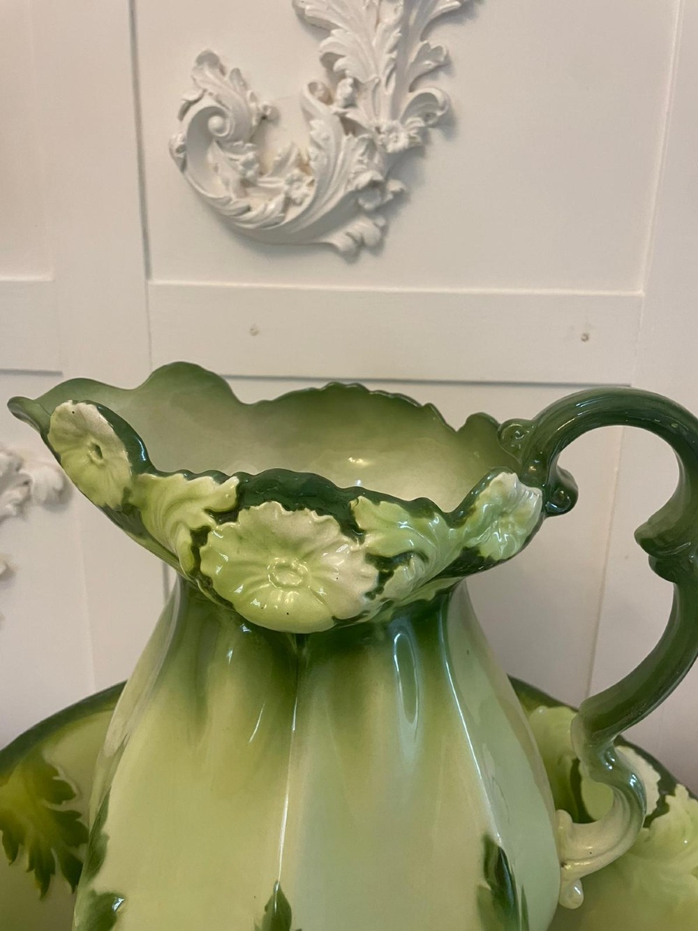 An Art Nouveau green and cream glazed ceramic jug with moulded relief leaf details resting inside a matching wash basin. View II