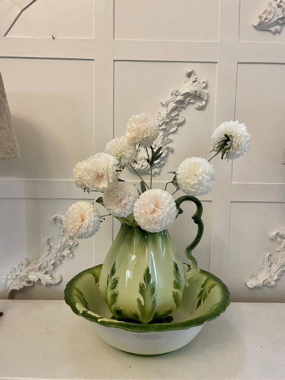 An Art Nouveau green and cream glazed ceramic jug with moulded relief leaf details resting inside a matching wash basin. View III