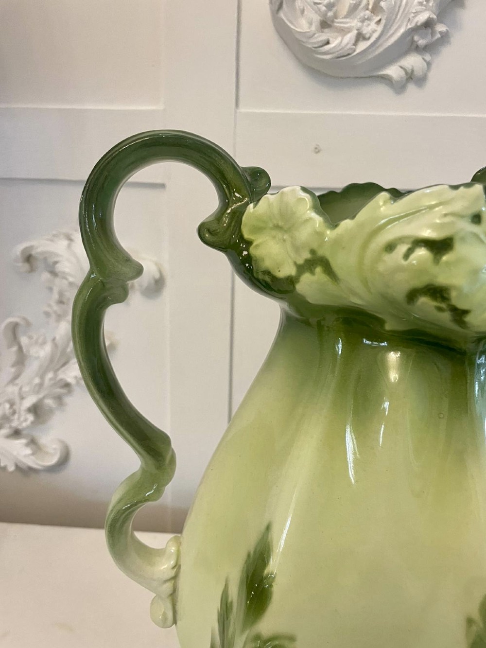 An Art Nouveau green and cream glazed ceramic jug with moulded relief leaf details resting inside a matching wash basin. View IV