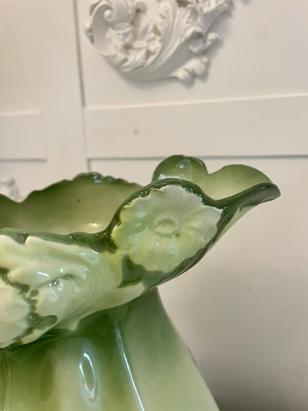An Art Nouveau green and cream glazed ceramic jug with moulded relief leaf details resting inside a matching wash basin. View V