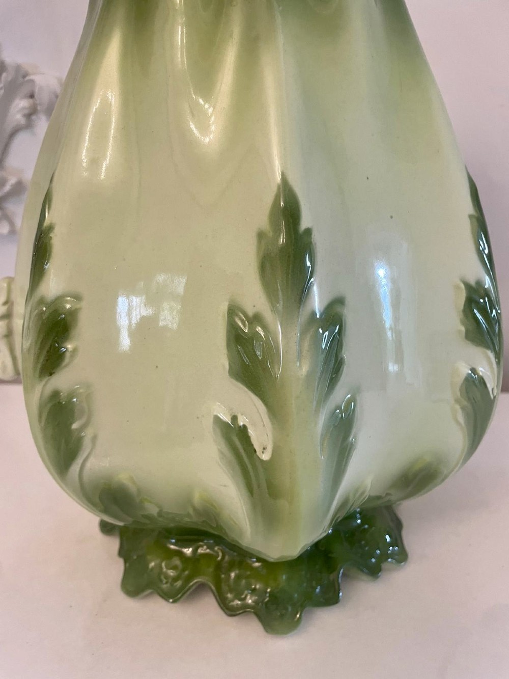 An Art Nouveau green and cream glazed ceramic jug with moulded relief leaf details resting inside a matching wash basin. View VI