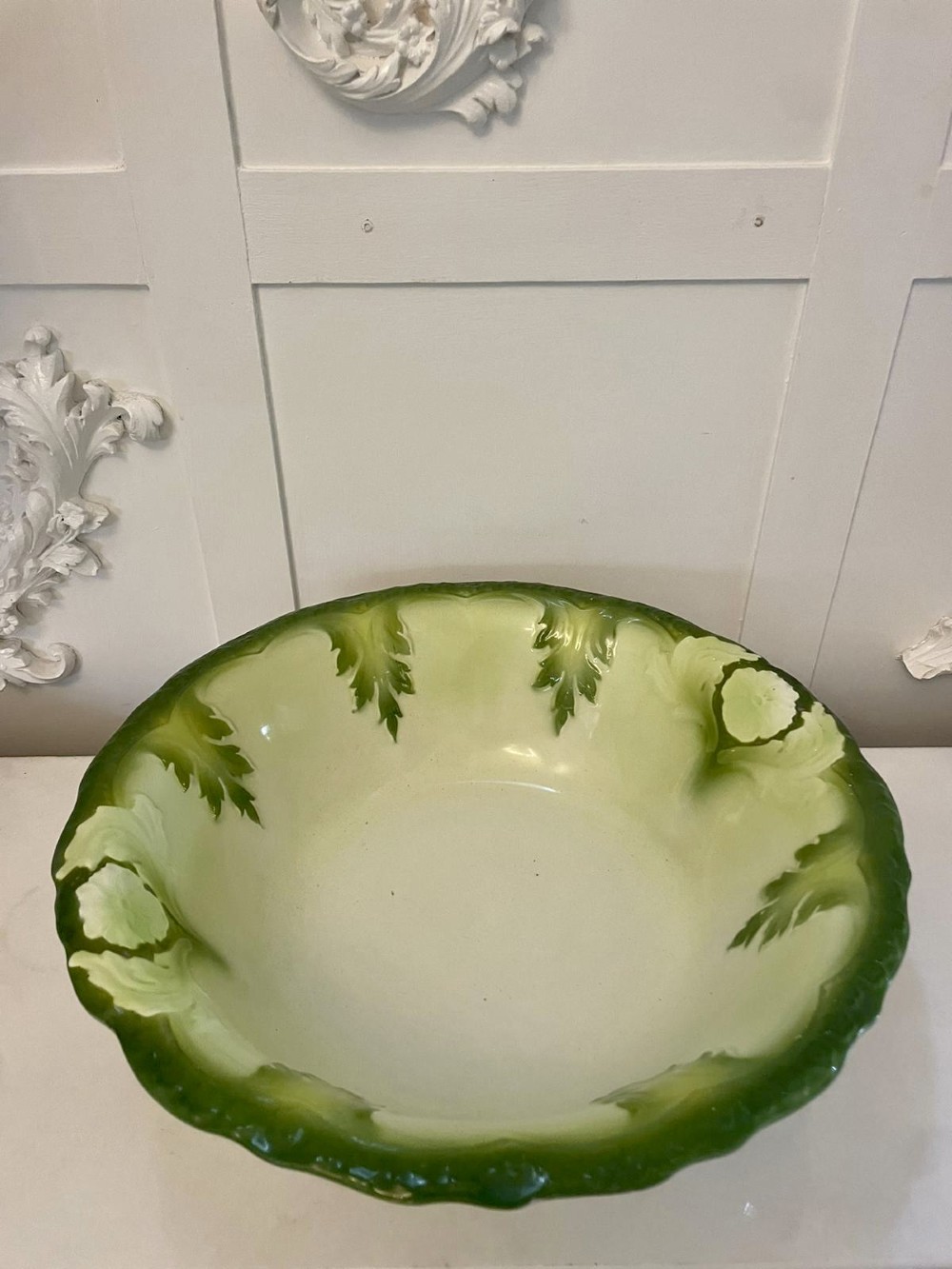 An Art Nouveau green and cream glazed ceramic jug with moulded relief leaf details resting inside a matching wash basin. View XV