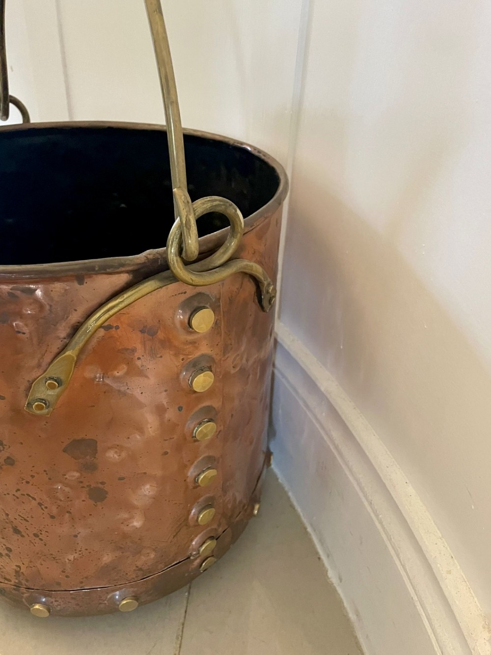 An antique copper coal bucket featuring a hand-hammered finish, brass swing handle, and a row of brass rivets around the lower rim. View II