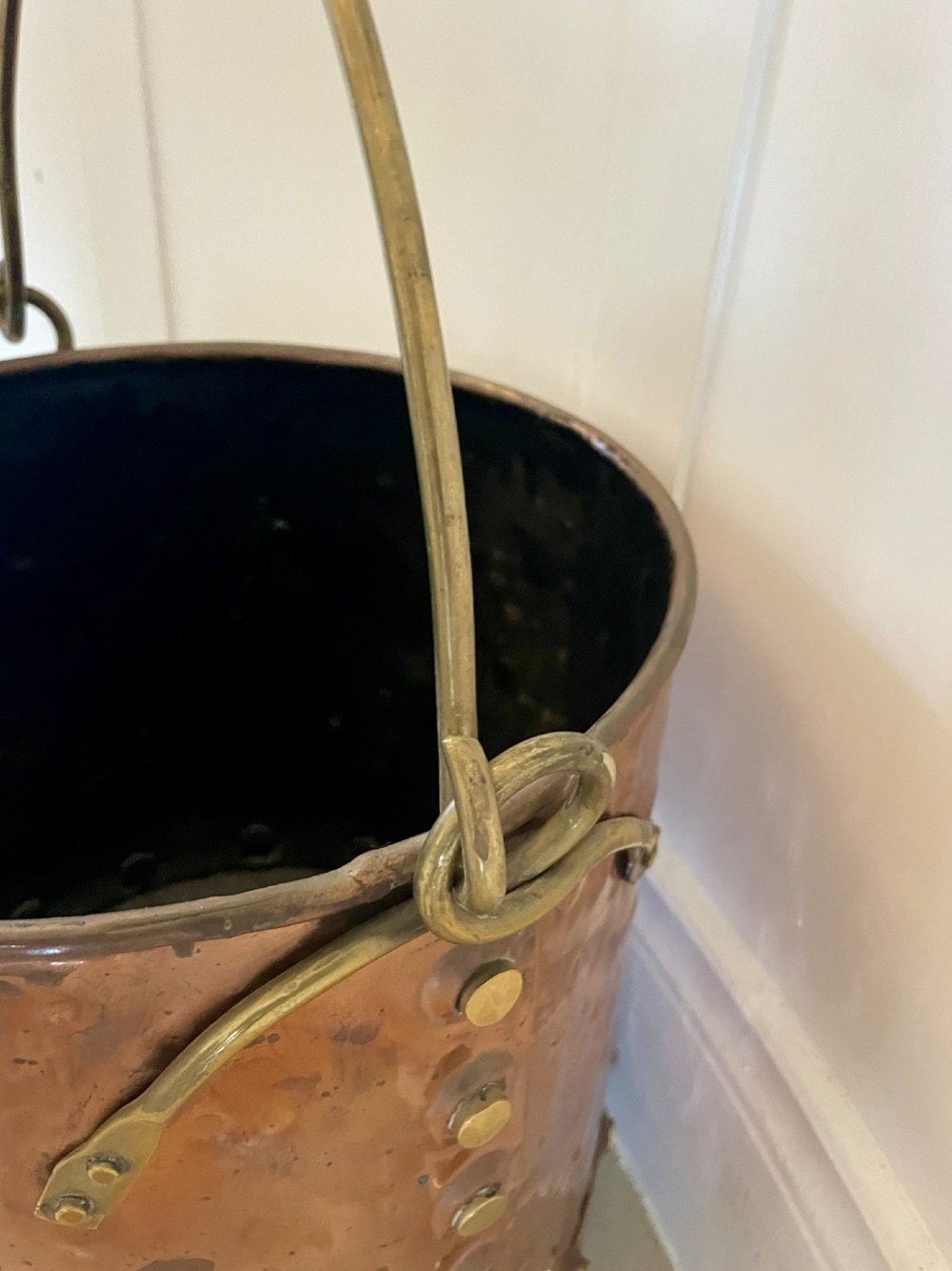 An antique copper coal bucket featuring a hand-hammered finish, brass swing handle, and a row of brass rivets around the lower rim. View III
