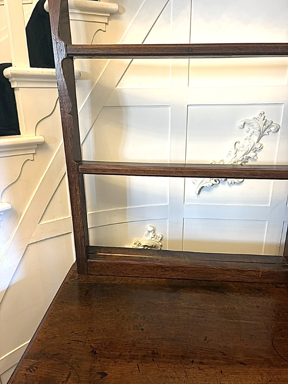 A dark oak Georgian Lancashire dresser with a scalloped open plate rack, central cupboard section, and base containing multiple drawers with brass handles. View XI