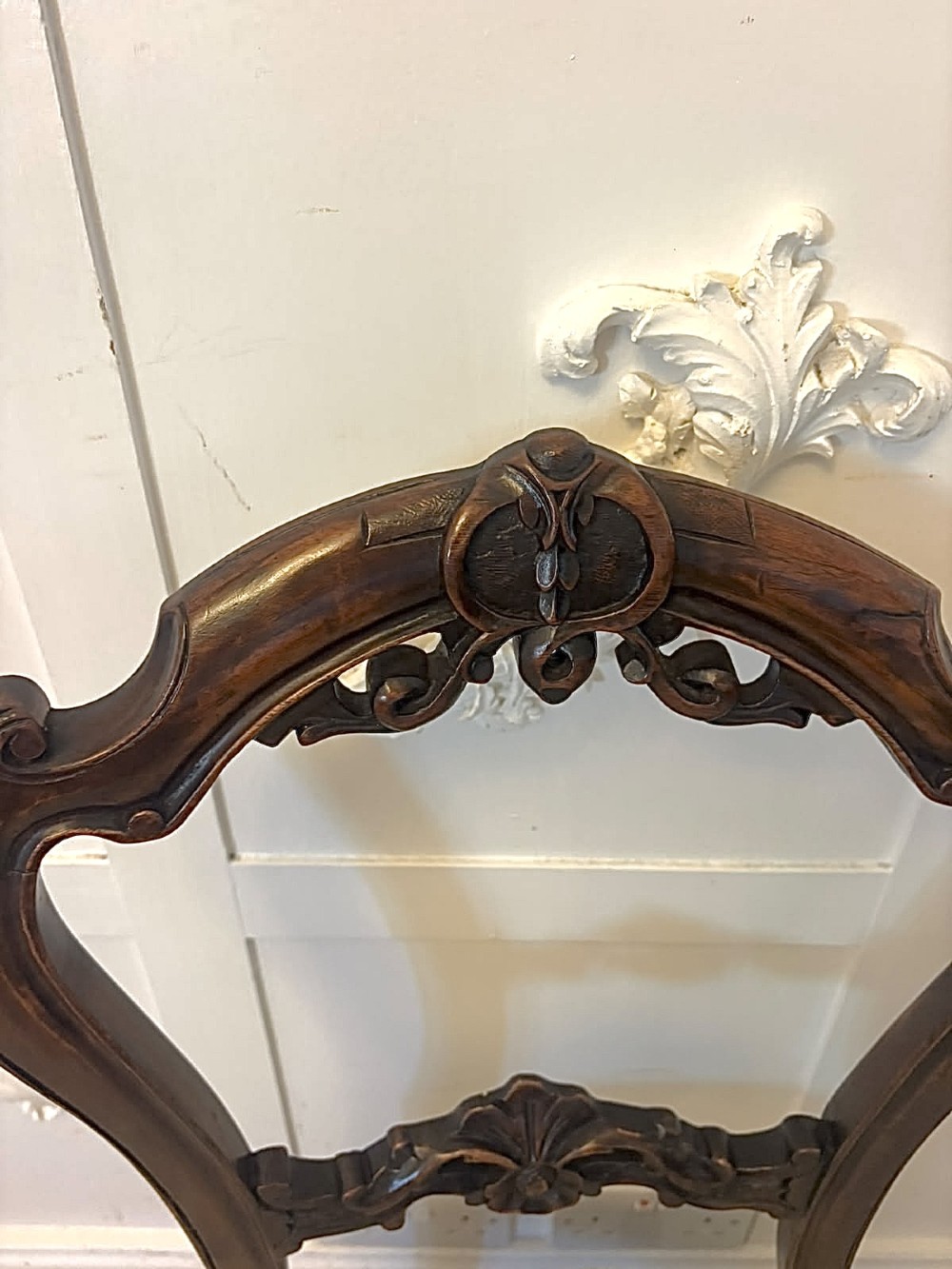 A set of four Victorian carved walnut dining chairs with open balloon-style backs and cream pattern-upholstered seats. View VII