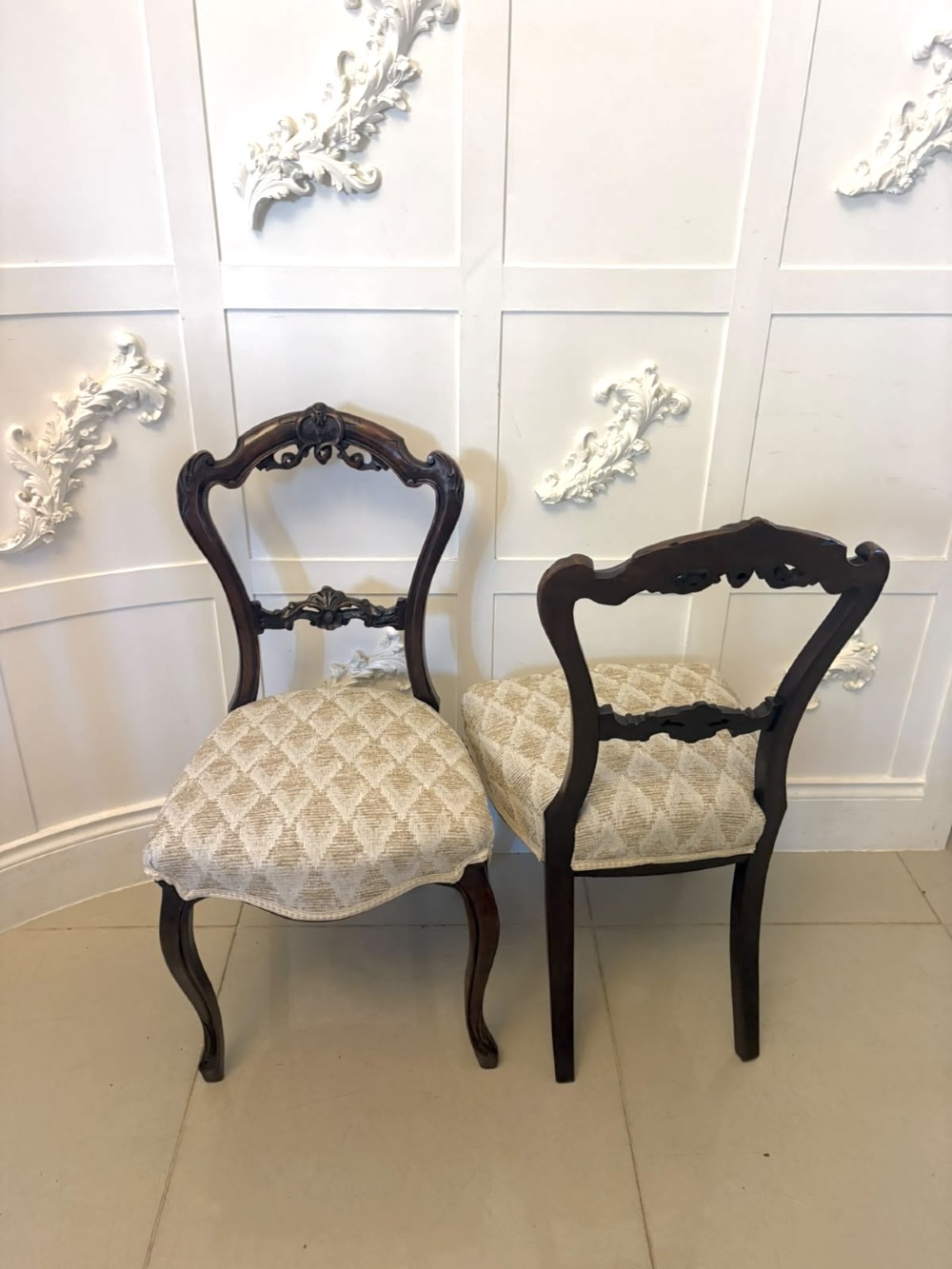 A set of four Victorian carved walnut dining chairs with open balloon-style backs and cream pattern-upholstered seats. View XIII