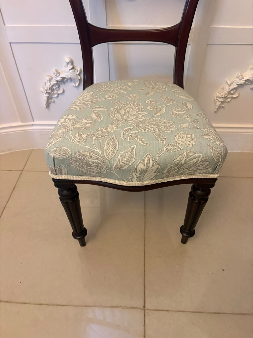 Set of six Victorian mahogany dining chairs featuring curved open backrests, reeded front legs, and light blue pattern-upholstered seats. View II