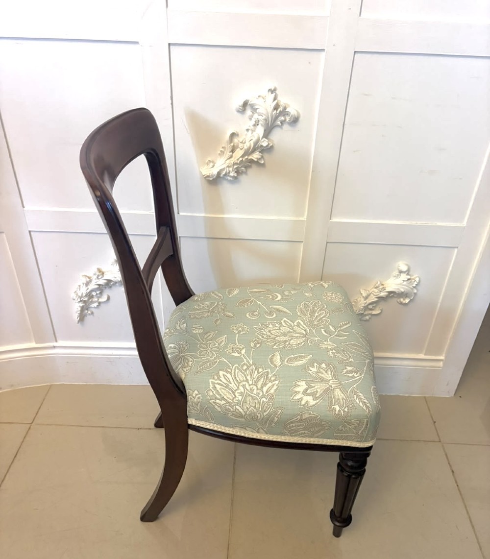 Set of six Victorian mahogany dining chairs featuring curved open backrests, reeded front legs, and light blue pattern-upholstered seats. View VIII