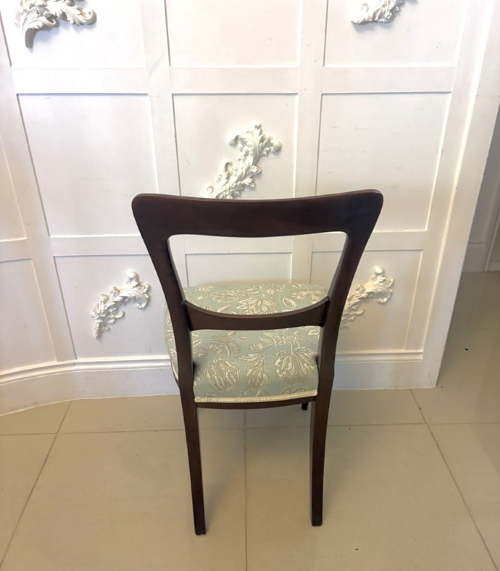 Set of six Victorian mahogany dining chairs featuring curved open backrests, reeded front legs, and light blue pattern-upholstered seats. View X