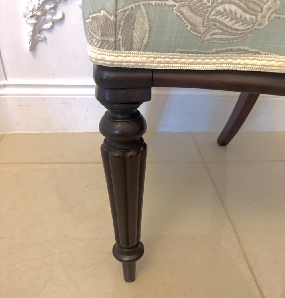 Set of six Victorian mahogany dining chairs featuring curved open backrests, reeded front legs, and light blue pattern-upholstered seats. View XI
