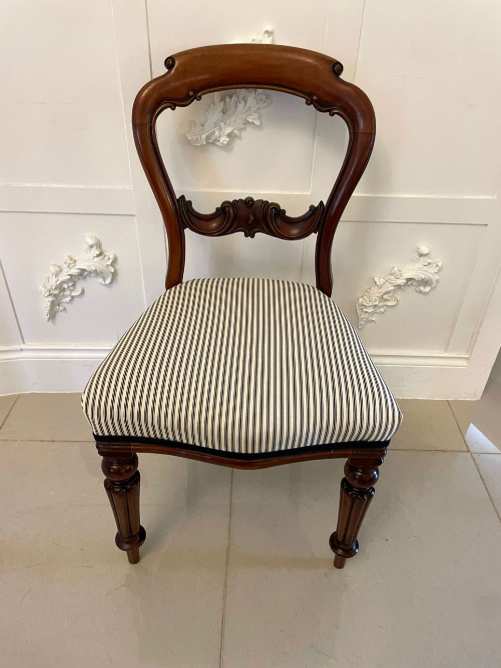 A set of six Victorian mahogany balloon back dining chairs with carved waist rails, turned front legs, and striped upholstered seats. View IV