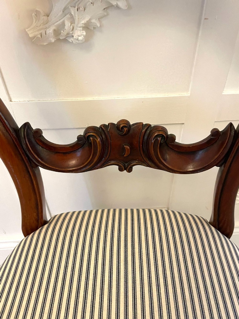 A set of six Victorian mahogany balloon back dining chairs with carved waist rails, turned front legs, and striped upholstered seats. View VII