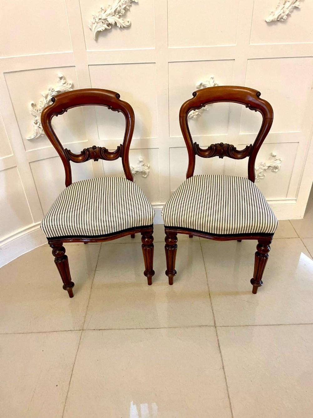 A set of six Victorian mahogany balloon back dining chairs with carved waist rails, turned front legs, and striped upholstered seats. View VIII