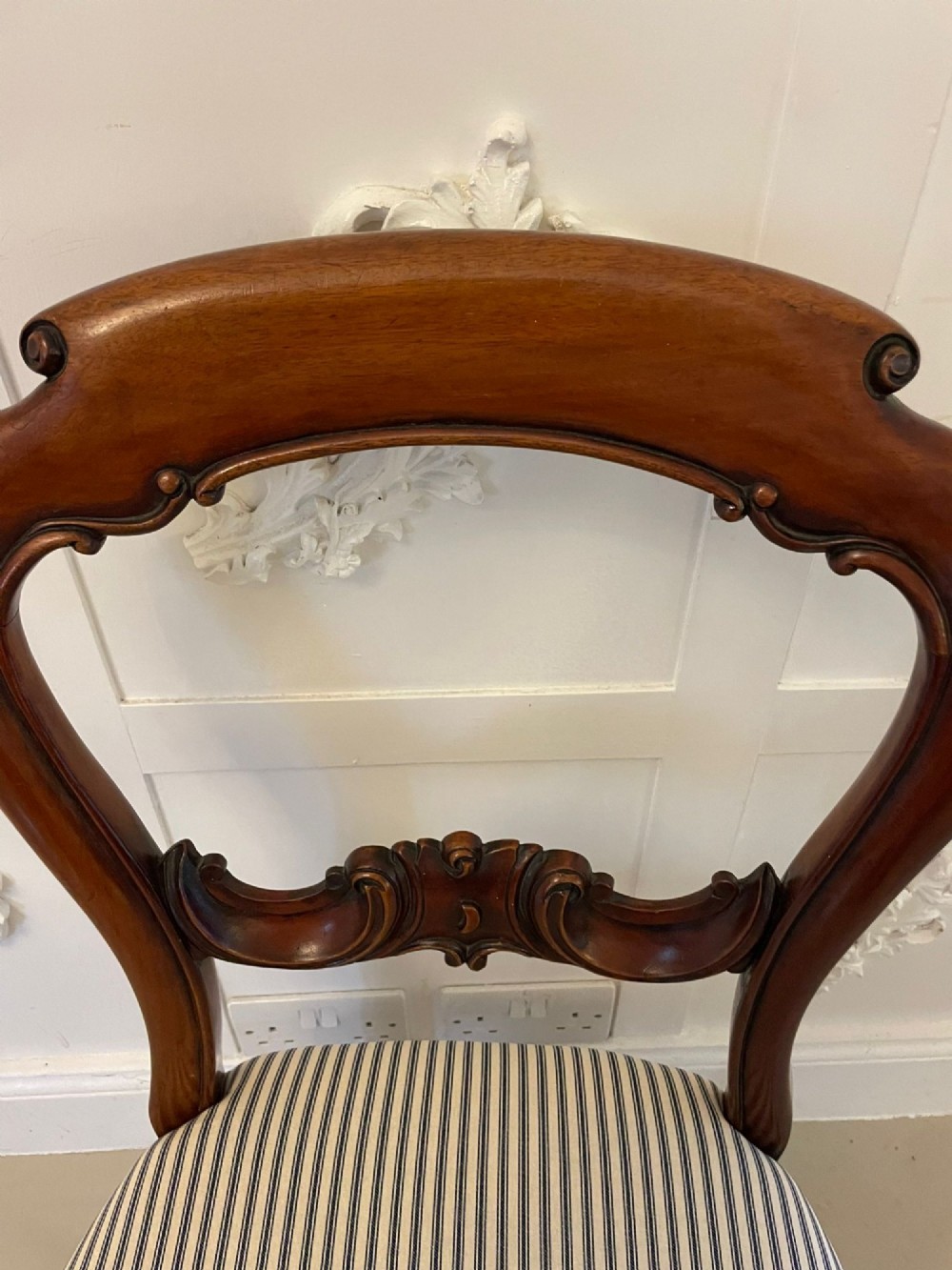 A set of six Victorian mahogany balloon back dining chairs with carved waist rails, turned front legs, and striped upholstered seats. View IX