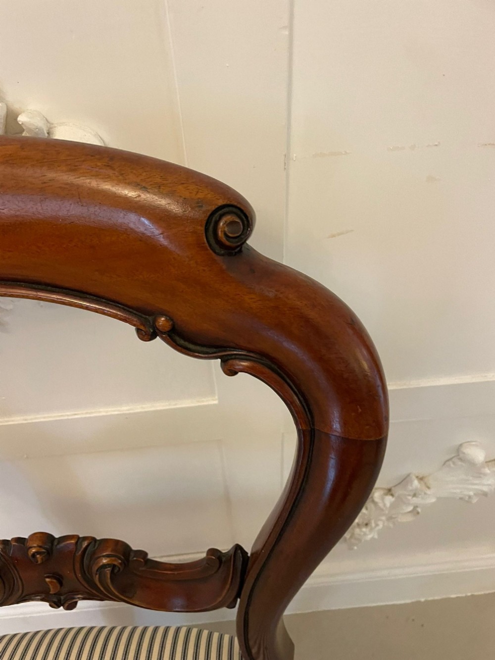 A set of six Victorian mahogany balloon back dining chairs with carved waist rails, turned front legs, and striped upholstered seats. View XI