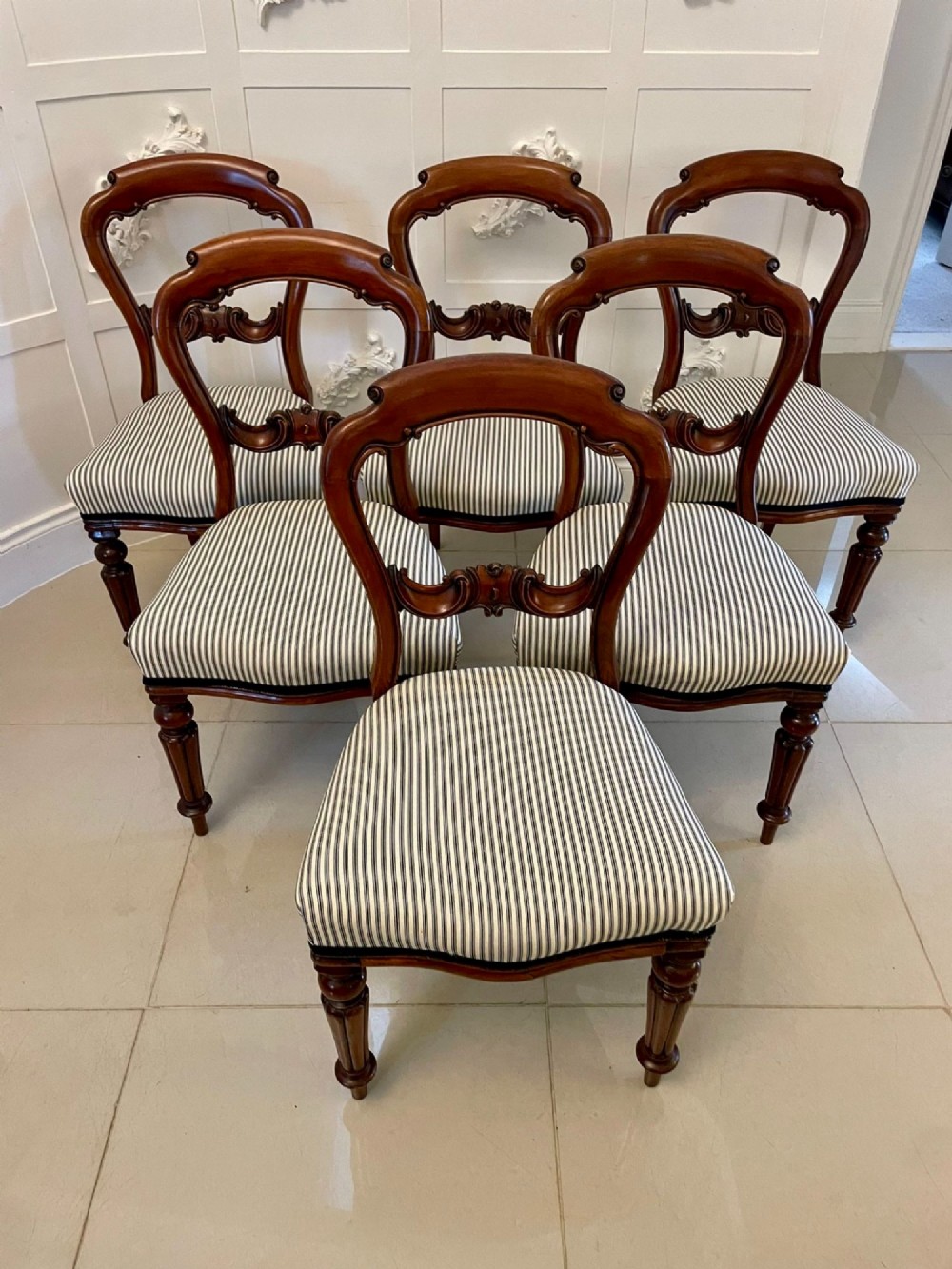 A set of six Victorian mahogany balloon back dining chairs with carved waist rails, turned front legs, and striped upholstered seats. View XIV