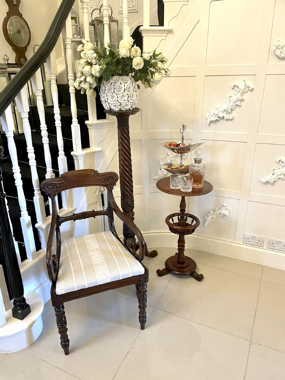 An antique Victorian circular mahogany lamp table featuring a central turned stem with an integrated balustrade mid-tier gallery, resting on a tripod base with scroll feet. View VIII