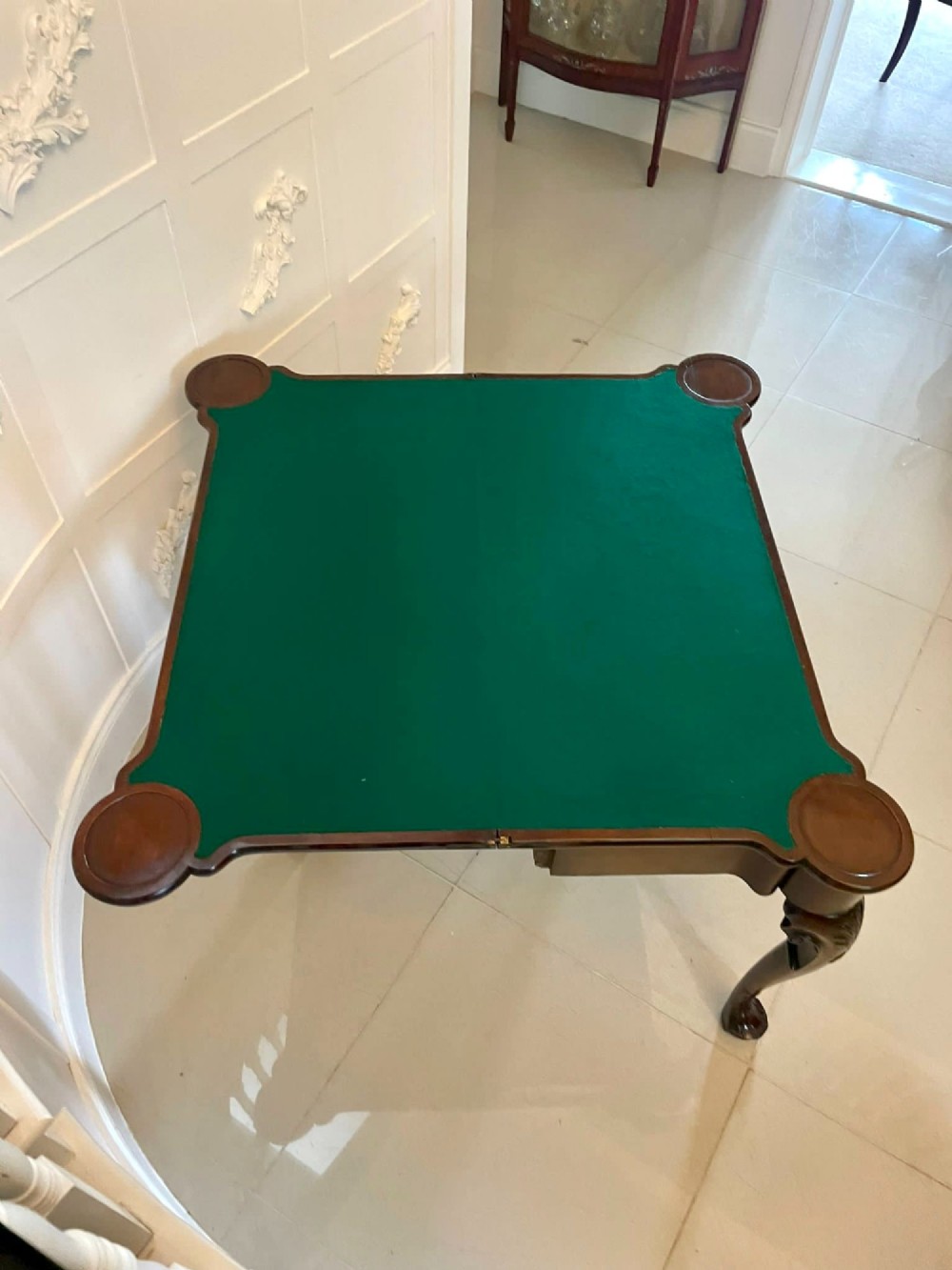 An 18th-century George II mahogany fold-over card table with carved cabriole legs, shell knees, and a central frieze drawer. View II