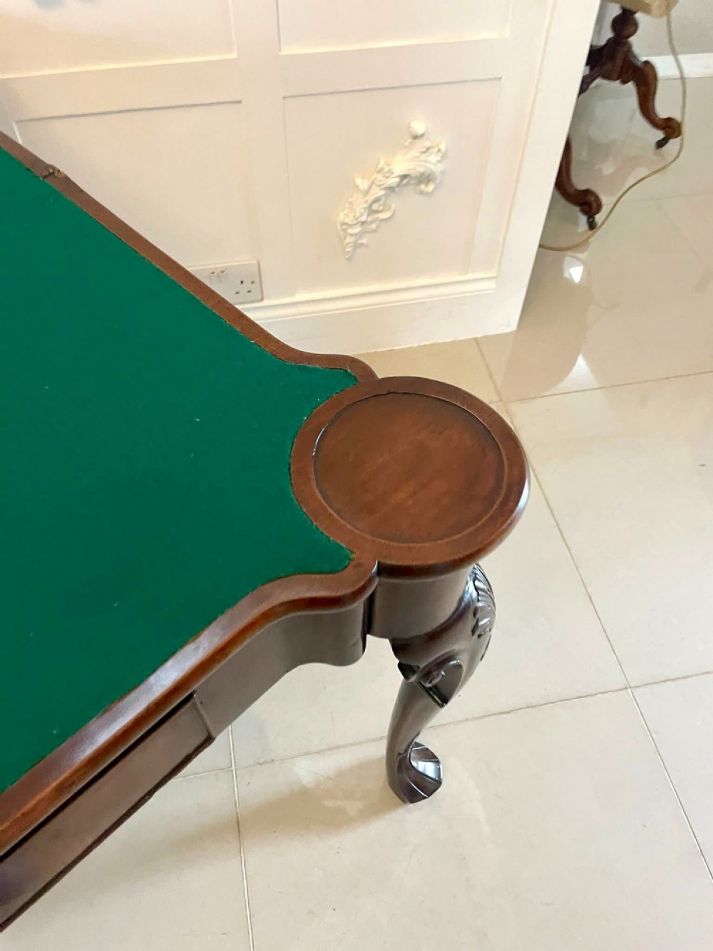 An 18th-century George II mahogany fold-over card table with carved cabriole legs, shell knees, and a central frieze drawer. View III